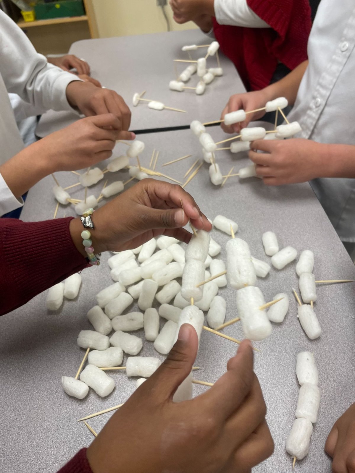 Students building towers from toothpicks and marshmallows at a STEMroots engineering workshop